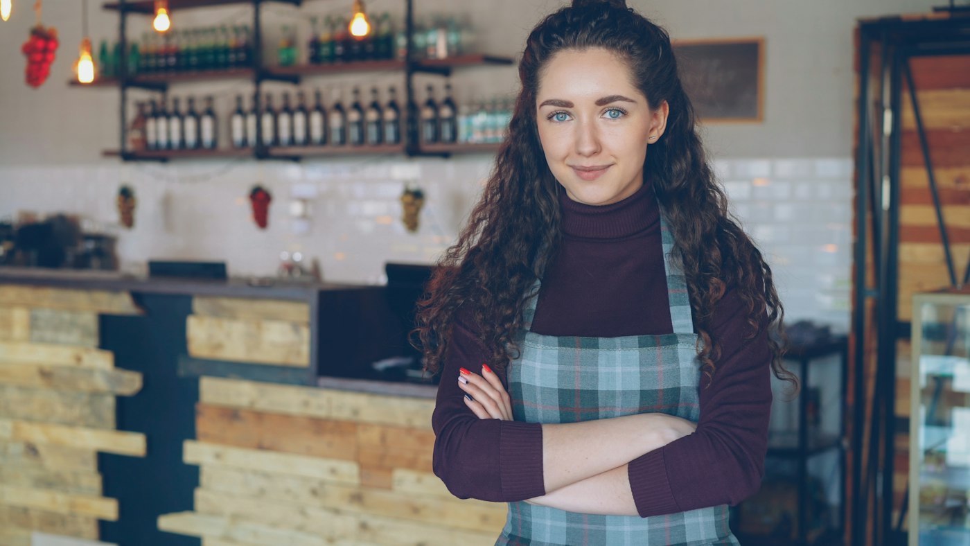Café owner standing in front of her counter