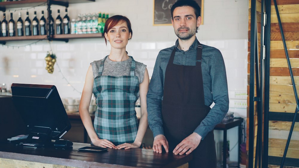 Two café owners at their counter